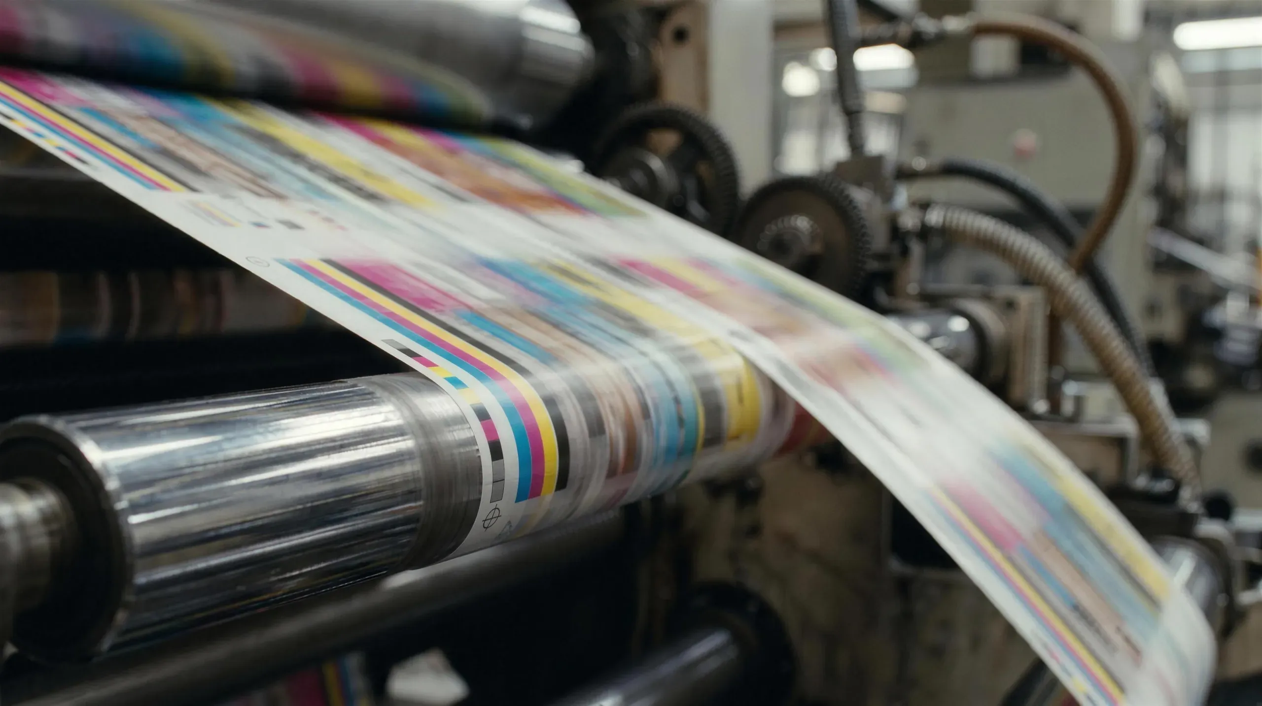 Printed film with colour registration bars running through a press at Varna